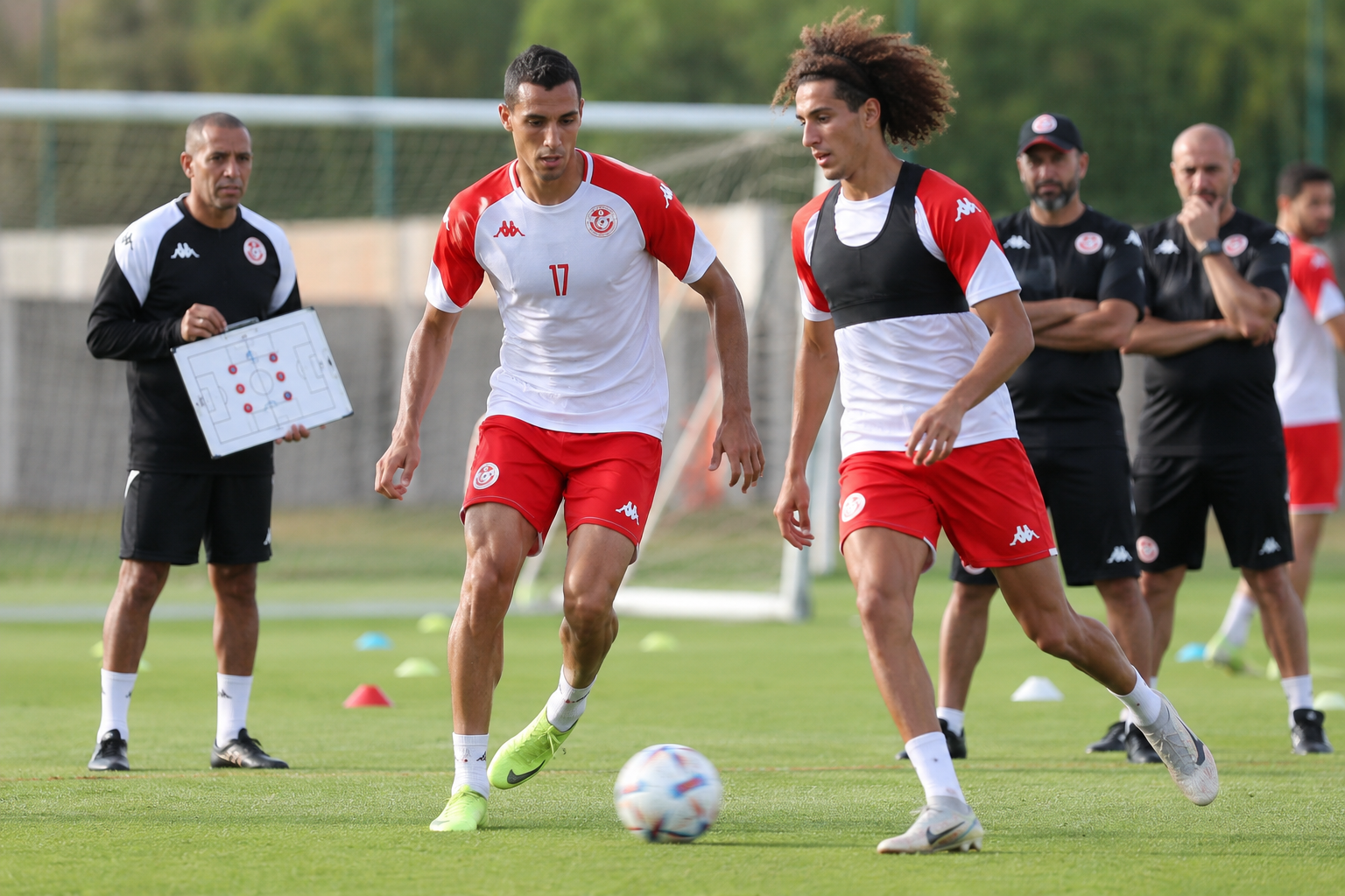 Detailed () action photography style image showing Tunisia national football team players in training session, coach Sabri
